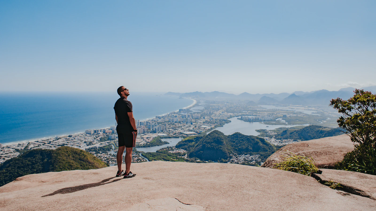 A visitor at a Tijuca Forest overlook above the Rio de Janeiro coastline